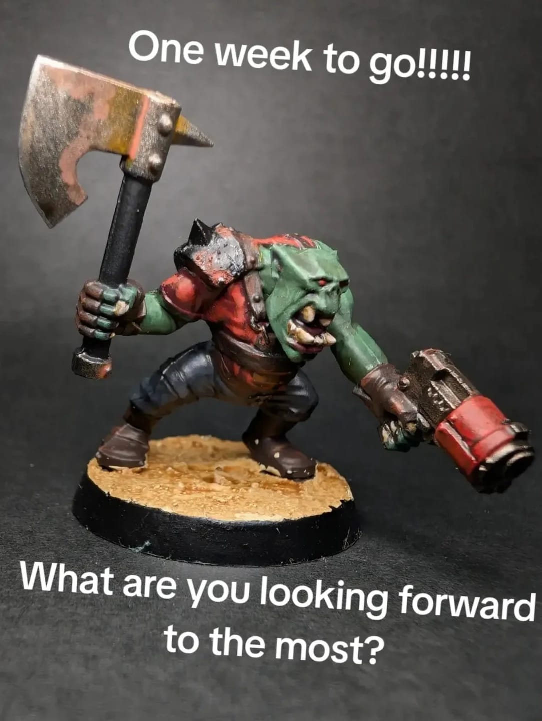 Ork miniature with a huge axe and red boots on a sand base
