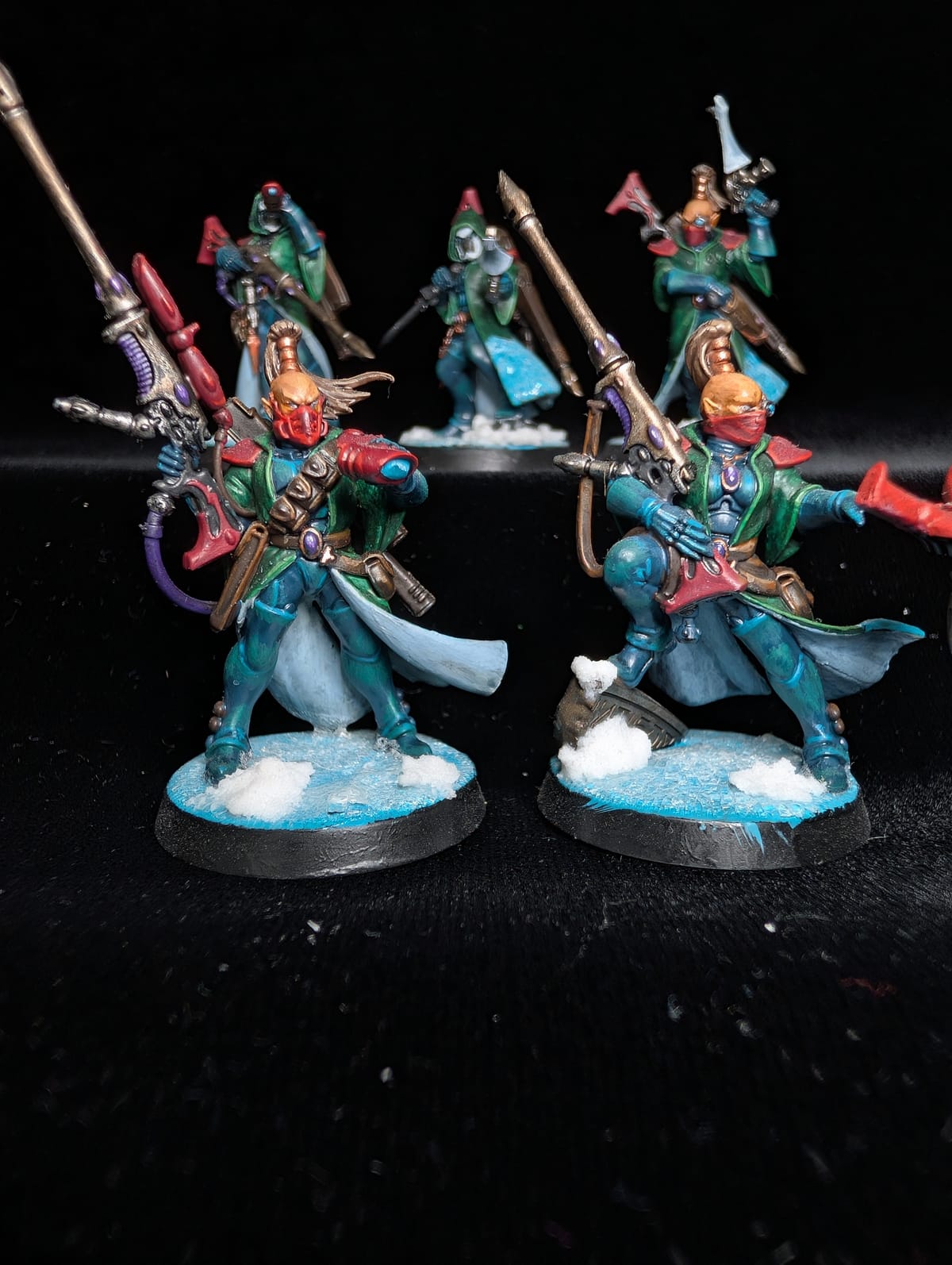 Squad of five Aeldari Rangers in teal cloaks with long rifles, on snow bases