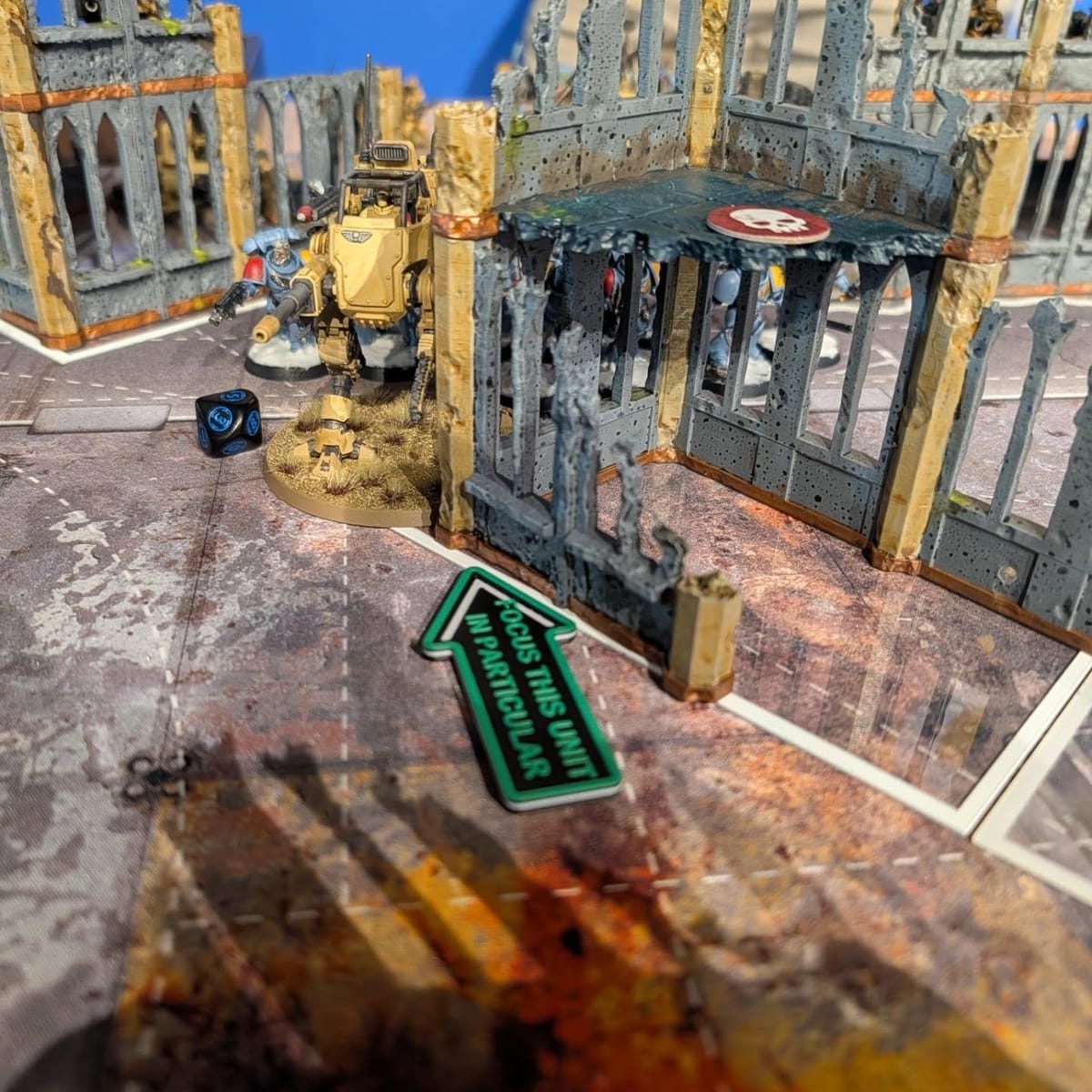 Painted ruined city terrain board with roads and rubble